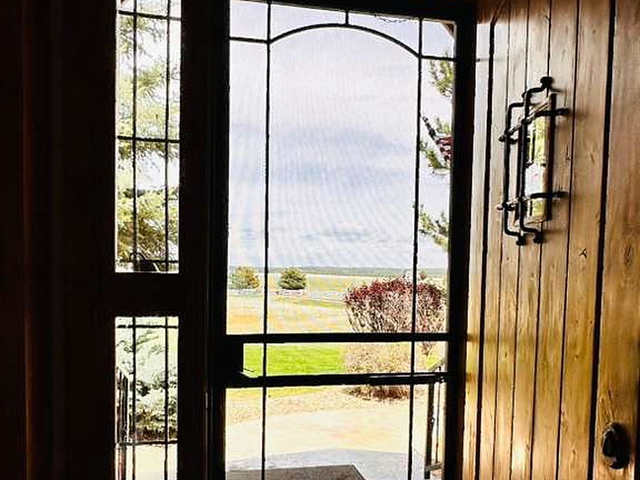 Front entry with a leaded glass door and cleaned tile floor