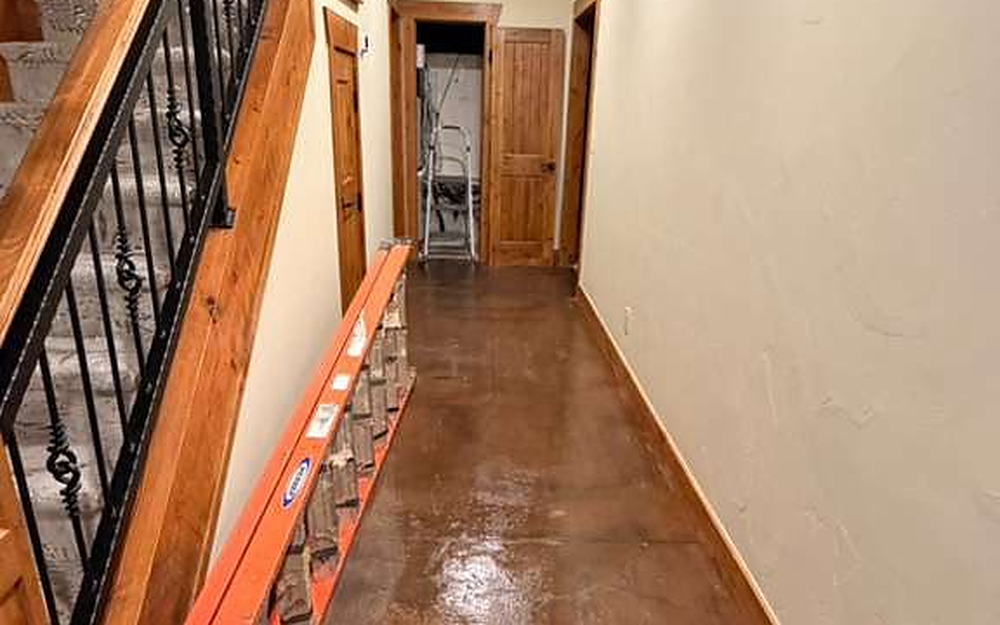 Hallway with a stained concrete floor cleaned during a working visit