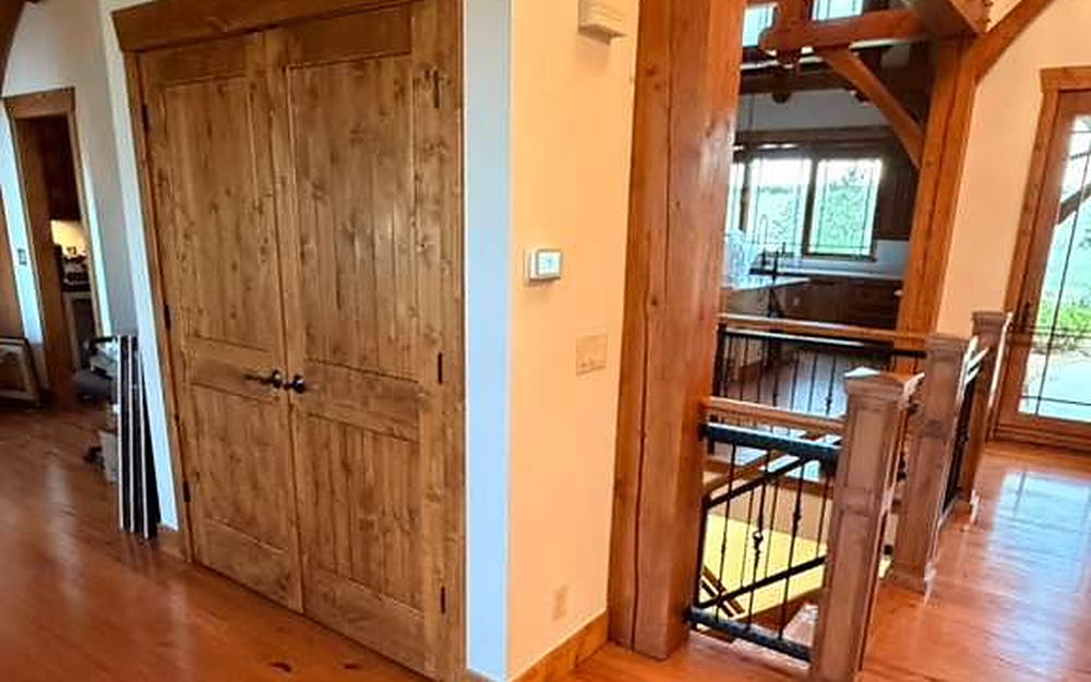 Upstairs landing with closet doors, timber posts and hardwood flooring cleaned
