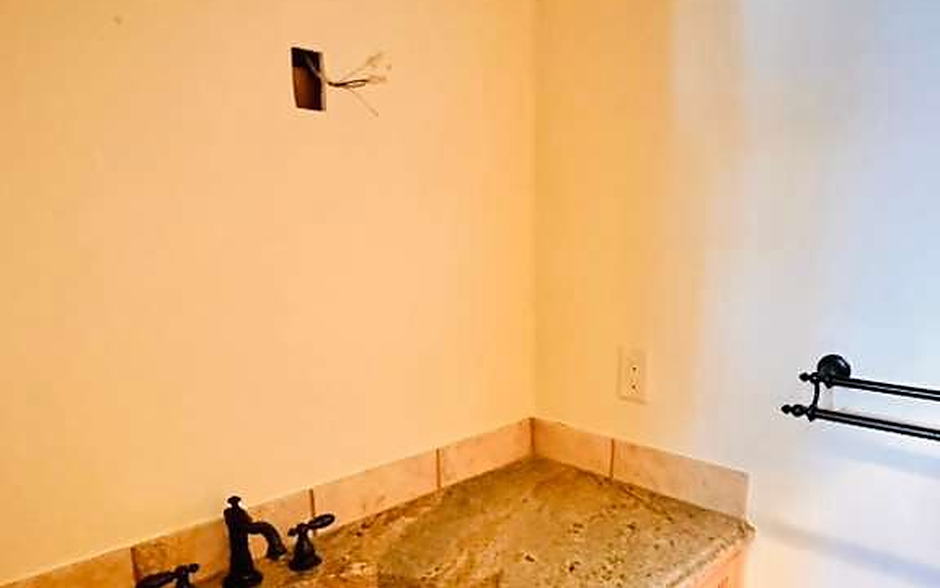 Bathroom with granite counter, oval sink and alder cabinets cleaned