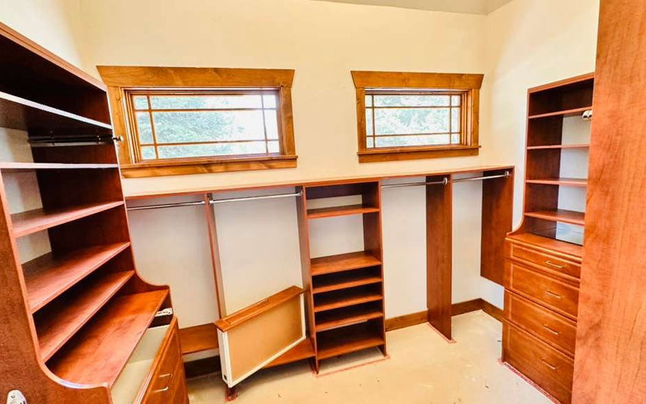 Walk-in closet with built-in wood shelving cleaned shelf by shelf