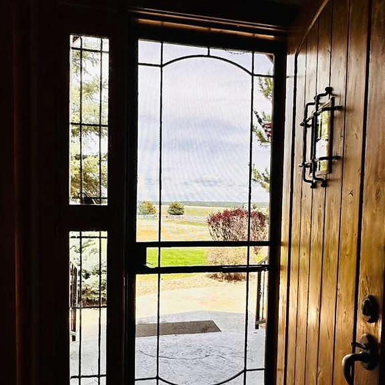 Front entry with a leaded glass door and cleaned tile floor