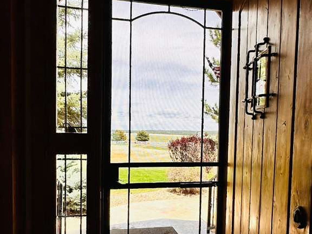 Front entry with a leaded glass door and cleaned tile floor