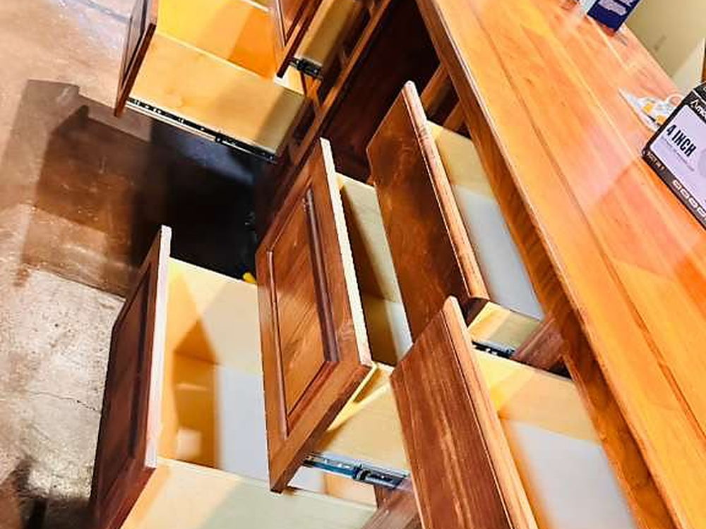Cabinet doors and drawers opened to clean every interior on a move-out job