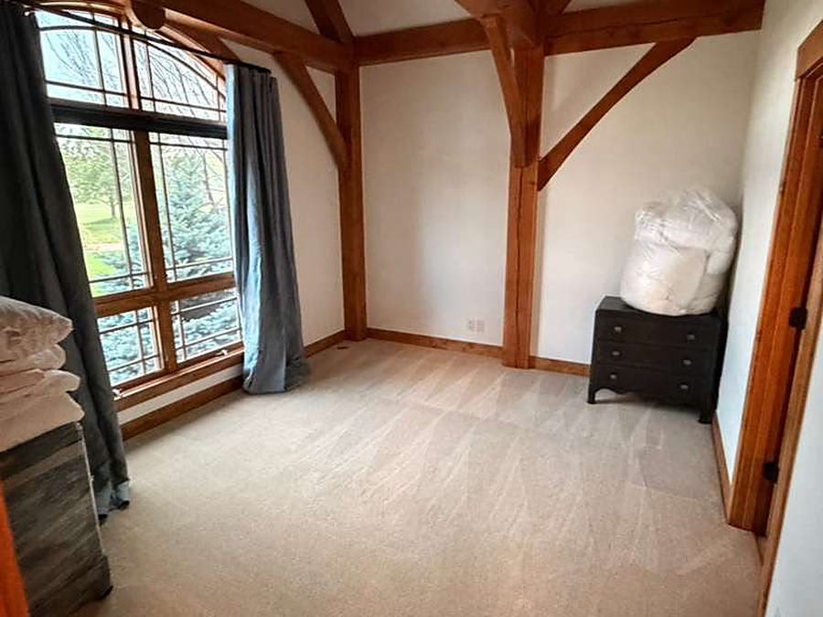 Empty carpeted room with the windows cleaned